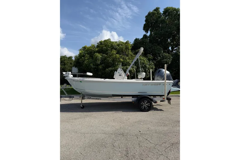 Slide: The Image of 2024 Key West 1720 Center Console boat on trailer, parked outdoors. - 2