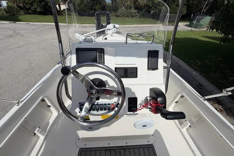 Slide: The Image of 2024 Key West 1720 Center Console boat dashboard with steering wheel and controls. - 13