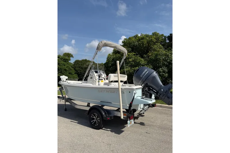 Slide: The Image of 2024 Key West 1720 Center Console boat on trailer, parked outdoors. - 5
