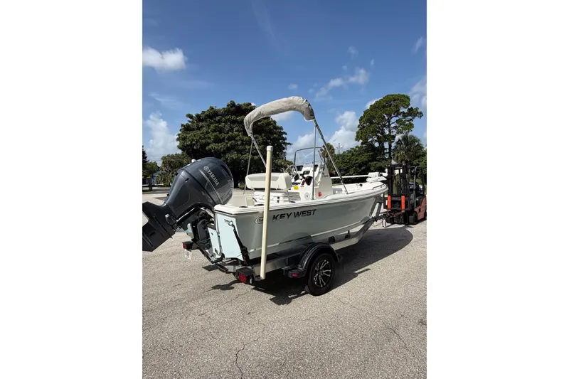 Slide: The Image of 2024 Key West 1720 Center Console boat with Yamaha engine on trailer, parked outdoors. - 8
