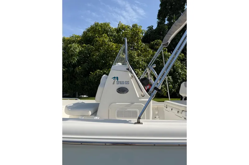 Slide: The Image of 2024 Key West 1720 Center Console boat with sleek design, set against lush greenery. - 4