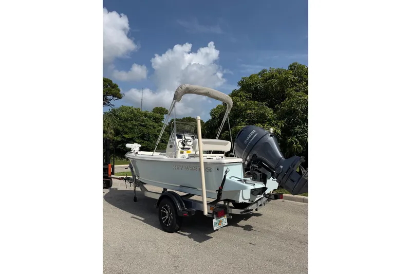 Slide: The Image of 2024 Key West 1720 Center Console boat on trailer, parked outdoors under a clear sky. - 6