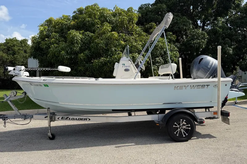 The Image of 2024 Key West 1720 Center Console boat on EZ Loader trailer, parked outdoors. - 0