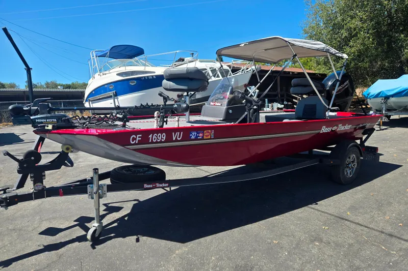 Slide: The Image of 2021 Tracker Bass Tracker Classic XL boat with canopy on trailer, parked outdoors. - 54
