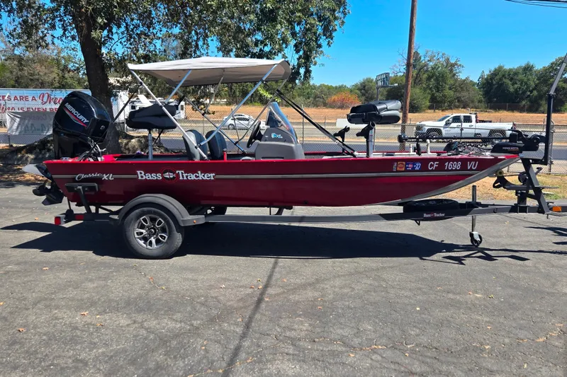 Slide: The Image of 2021 Tracker Bass Tracker Classic XL boat on trailer, parked outdoors. - 48