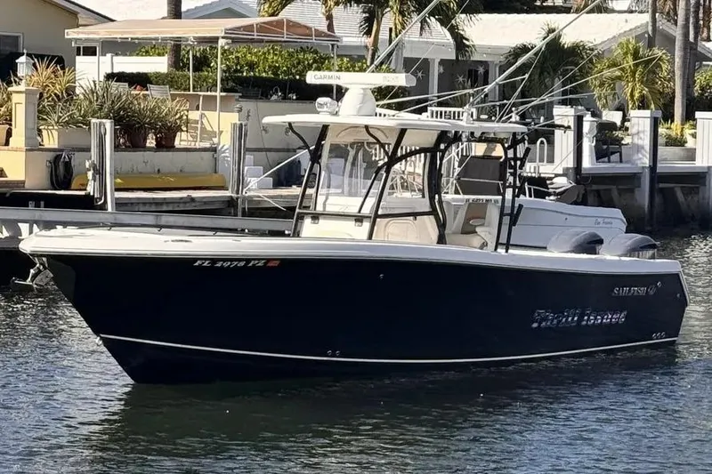Slide: The Image of 2015 Sailfish 320 CC boat docked in a marina, featuring sleek design and modern equipment. - 1