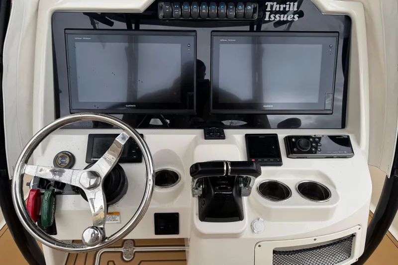 Slide: The Image of Control panel of a 2015 Sailfish 320 CC boat with dual Garmin screens. - 11