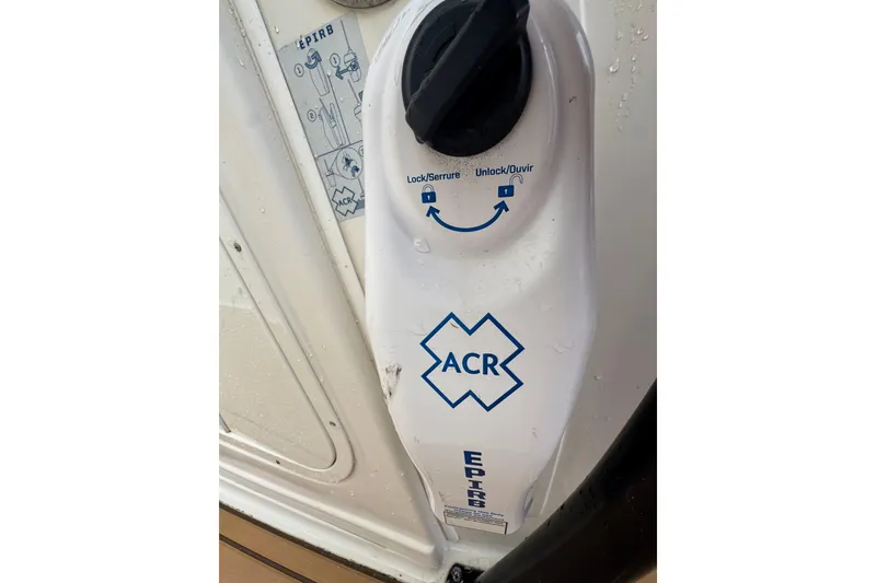 Slide: The Image of EPIRB device on 2015 Sailfish 320 CC boat, featuring ACR logo and lock mechanism. - 25
