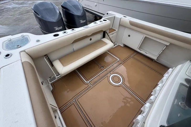 Slide: The Image of 2015 Sailfish 320 CC boat interior with foldable seat and twin Yamaha 300 engines. - 9
