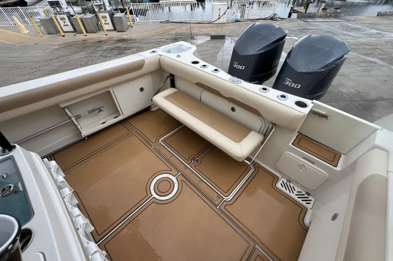 Slide: The Image of 2015 Sailfish 320 CC boat interior with seating and twin outboard engines. - 8