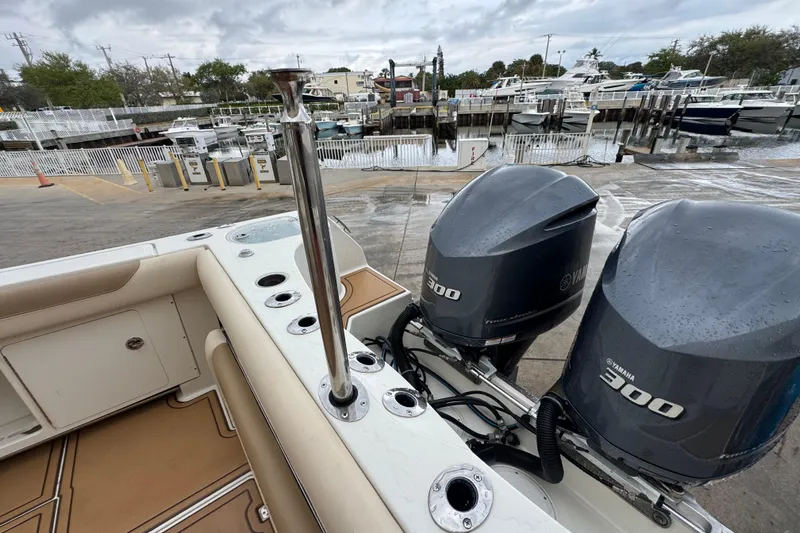 Slide: The Image of 2015 Sailfish 320 CC boat with twin Yamaha 300 engines at a marina dock. - 10