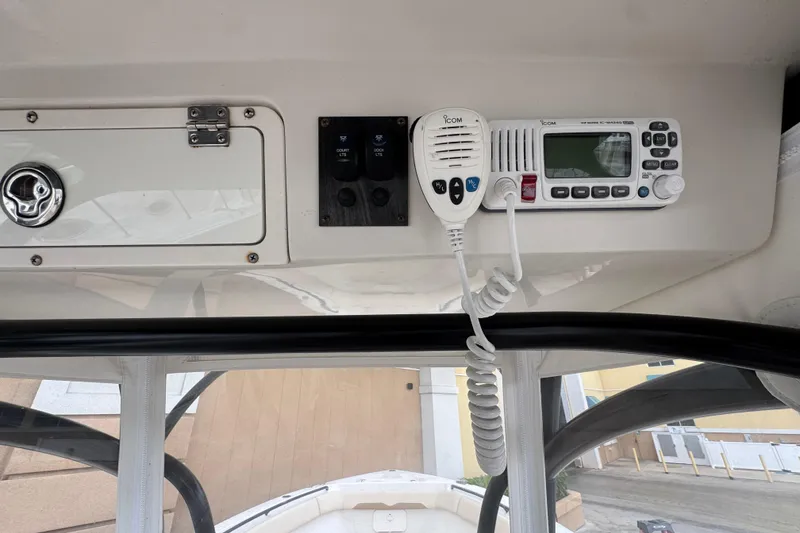 Slide: The Image of 2015 Sailfish 320 CC boat console with radio and control panel. - 21