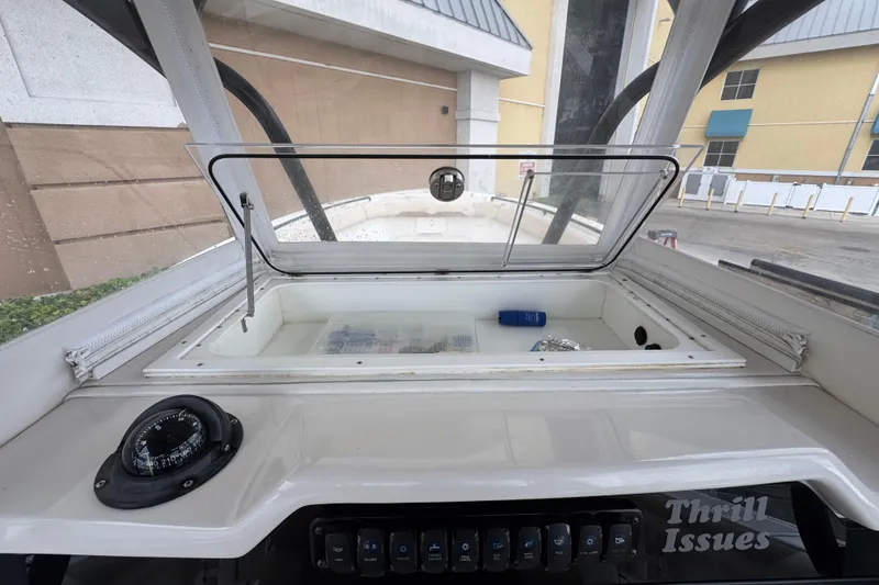 Slide: The Image of Interior view of a 2015 Sailfish 320 CC boat console with storage compartment. - 24