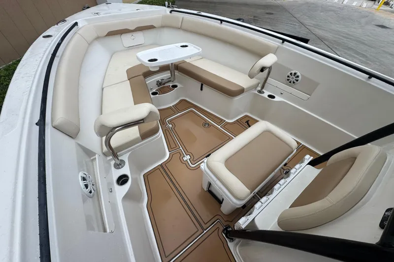 Slide: The Image of Interior of a 2015 Sailfish 320 CC boat with beige seating and table. - 18