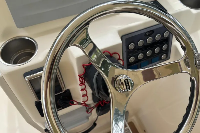 Slide: The Image of Steering wheel and control panel of 2016 Scout 275 Dorado boat cockpit. - 15