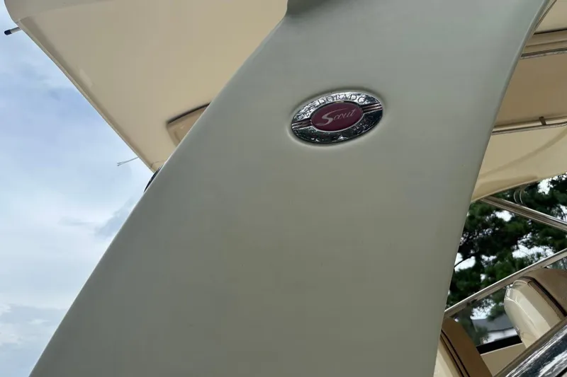 Slide: The Image of 2016 Scout 275 Dorado boat emblem with sleek design and partial interior view. - 25