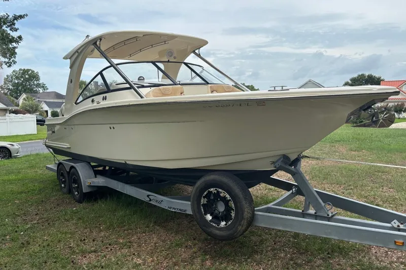 Slide: The Image of 2016 Scout 275 Dorado boat on trailer, parked on grass in residential area. - 1