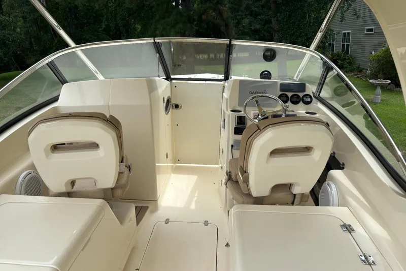 Slide: The Image of 2016 Scout 275 Dorado boat interior with helm, seats, and dashboard. - 9