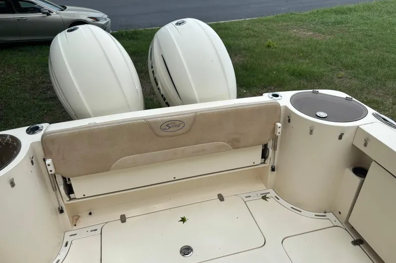 Slide: The Image of 2016 Scout 275 Dorado boat interior with dual Yamaha engines, beige seating, and storage compartments. - 6