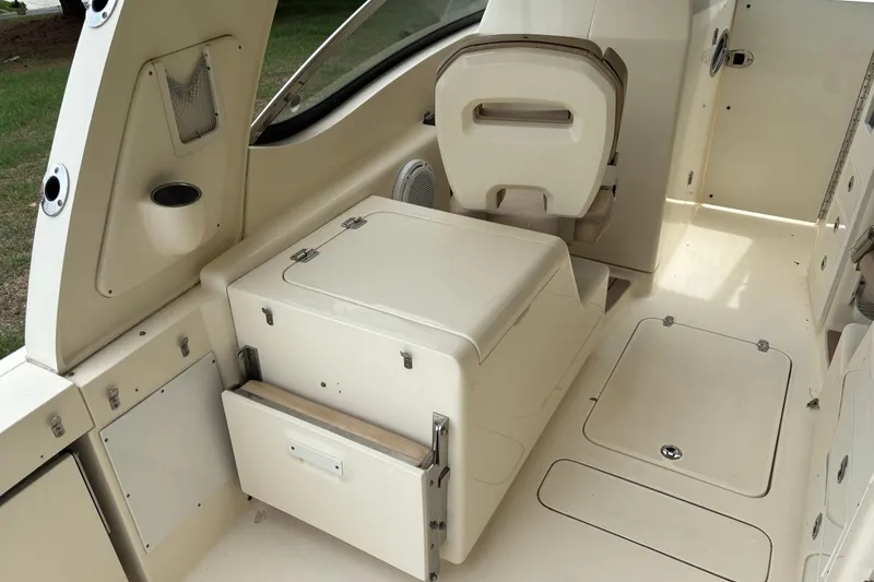 Slide: The Image of Interior of a 2016 Scout 275 Dorado boat, featuring seating and storage compartments. - 11