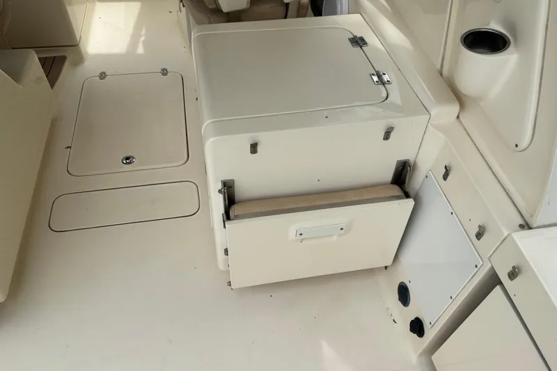 Slide: The Image of 2016 Scout 275 Dorado boat interior with storage compartments and seating. - 8