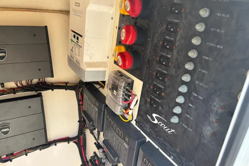 Slide: The Image of Electrical panel of a 2016 Scout 275 Dorado boat with switches and wiring. - 17