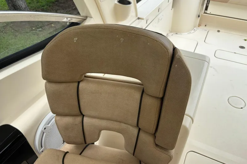 Slide: The Image of 2016 Scout 275 Dorado boat seat with beige upholstery and black accents. - 12
