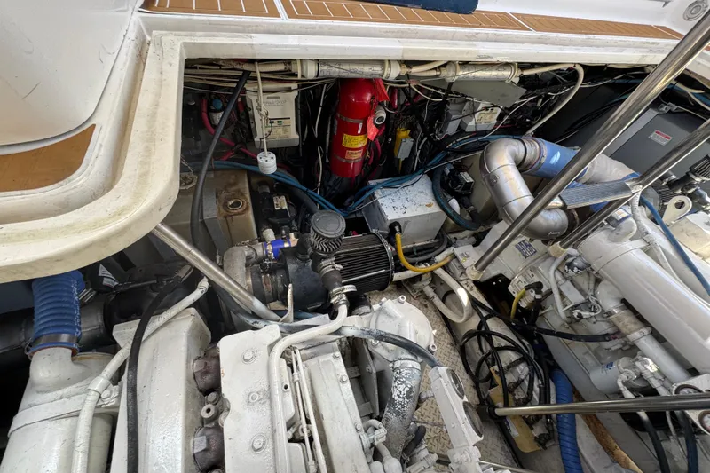 Slide: The Image of Engine compartment of a 2003 Sea Ray 45 Express Bridge, showcasing mechanical components and wiring. - 20