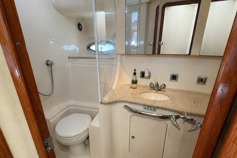 Slide: The Image of Luxurious bathroom in 2003 Sea Ray 450 Express Bridge yacht, featuring modern fixtures and elegant design. - 17