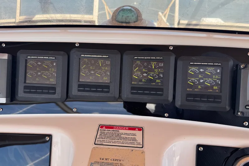 Slide: The Image of Dashboard of a 2003 Sea Ray 45 Express Bridge with marine diesel displays. - 7