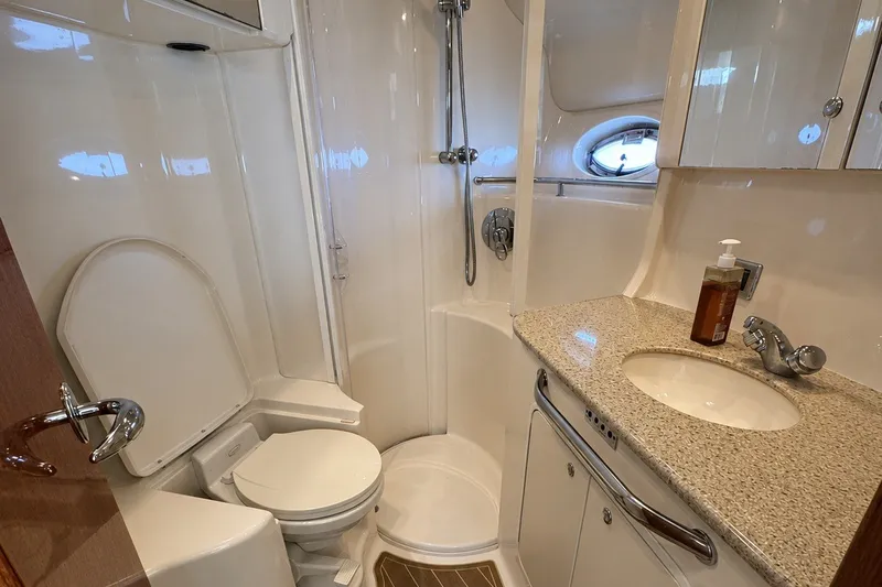 Slide: The Image of Luxurious bathroom in 2003 Sea Ray 450 Express Bridge yacht, featuring shower and sink. - 15