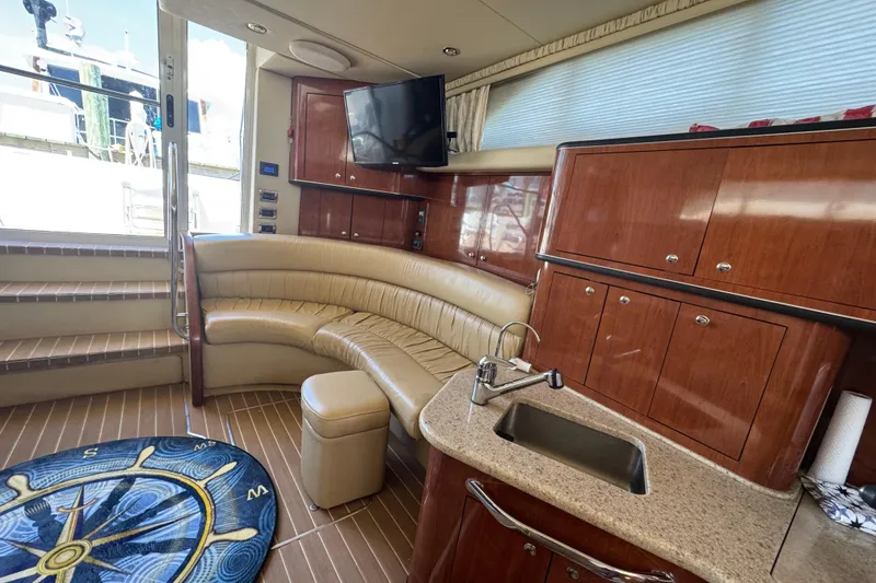 Slide: The Image of Luxurious interior of 2003 Sea Ray 45 Express Bridge yacht with leather seating and kitchenette. - 11