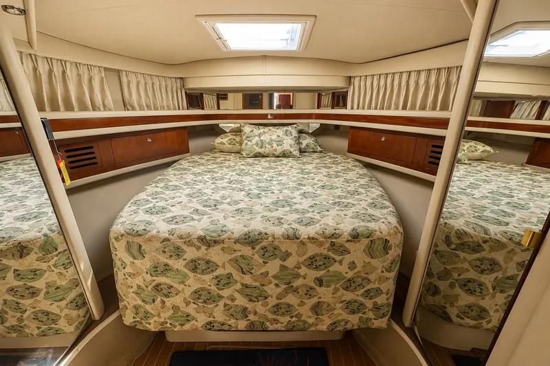 Slide: The Image of Luxurious cabin interior of 2003 Sea Ray 450 Express Bridge with patterned bedding. - 13