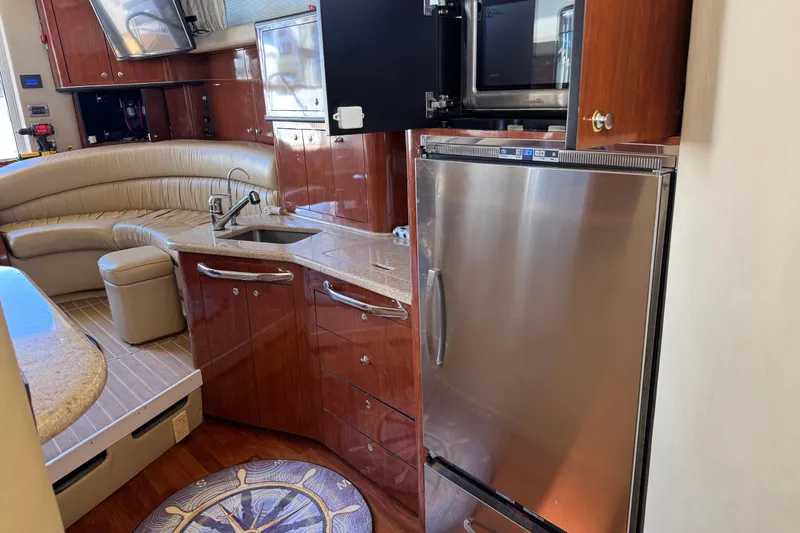 Slide: The Image of Luxurious 2003 Sea Ray 45 Express Bridge yacht interior with modern kitchen amenities. - 12