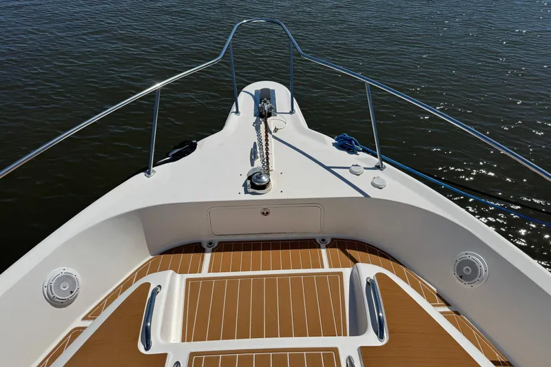 Slide: The Image of Bow view of 2003 Sea Ray 45 Express Bridge yacht on calm water. - 2