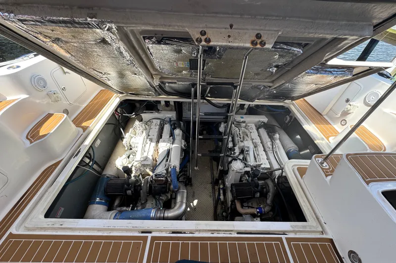 Slide: The Image of Engine compartment of a 2003 Sea Ray 45 Express Bridge, showcasing dual engines. - 19