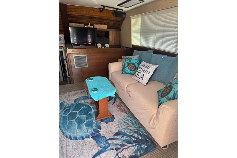 Slide: The Image of Cozy 1979 Post 42 Convertible yacht interior with nautical decor and comfortable seating. - 3