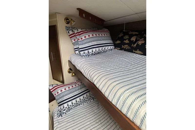 Slide: The Image of Nautical-themed bunk beds in a 1979 Post 42 Convertible boat cabin. - 5