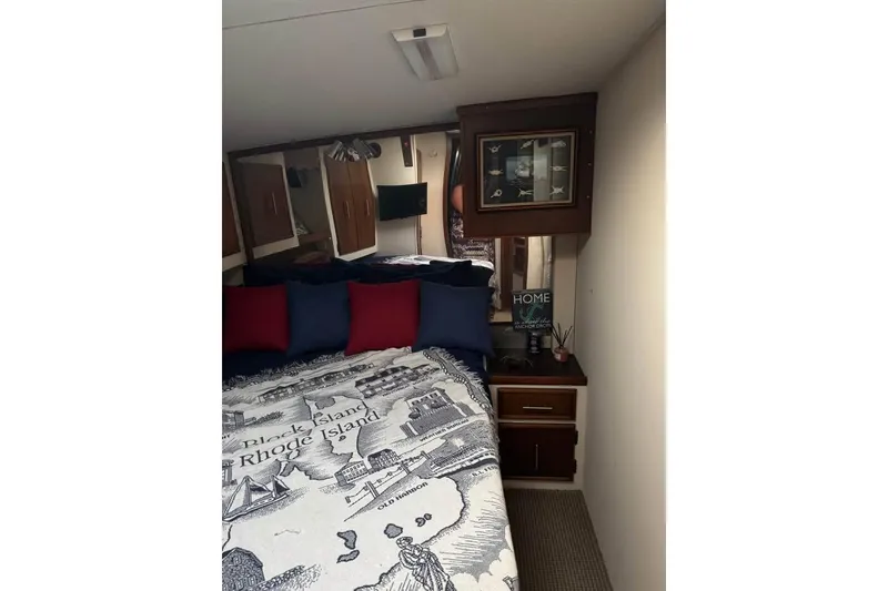 Slide: The Image of Cozy bedroom interior of a 1979 Post 42 Convertible yacht with nautical decor. - 7