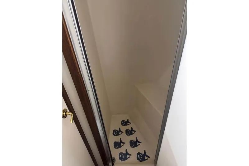 Slide: The Image of Narrow shower stall with fish-patterned mat in 1979 Post 42 Convertible boat. - 9