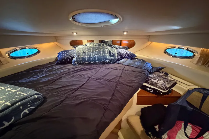 Slide: The Image of Cozy cabin interior of 2007 Regal Commodore 3760 IO with nautical-themed bedding. - 38