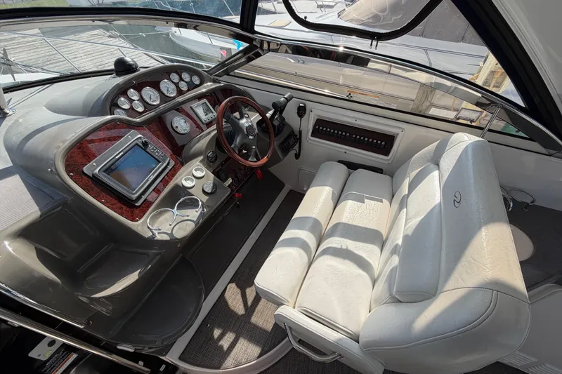 Slide: The Image of 2007 Regal Commodore 3760 IO boat cockpit with steering wheel, gauges, and white seating. - 11