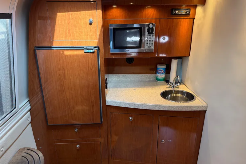 Slide: The Image of 2007 Regal Commodore 3760 IO yacht kitchen with microwave, fridge, and sink. - 29