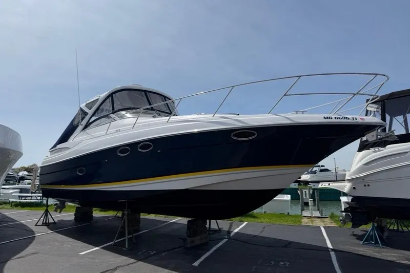 Slide: The Image of 2007 Regal Commodore 3760 IO boat on stands in a marina setting. - 1