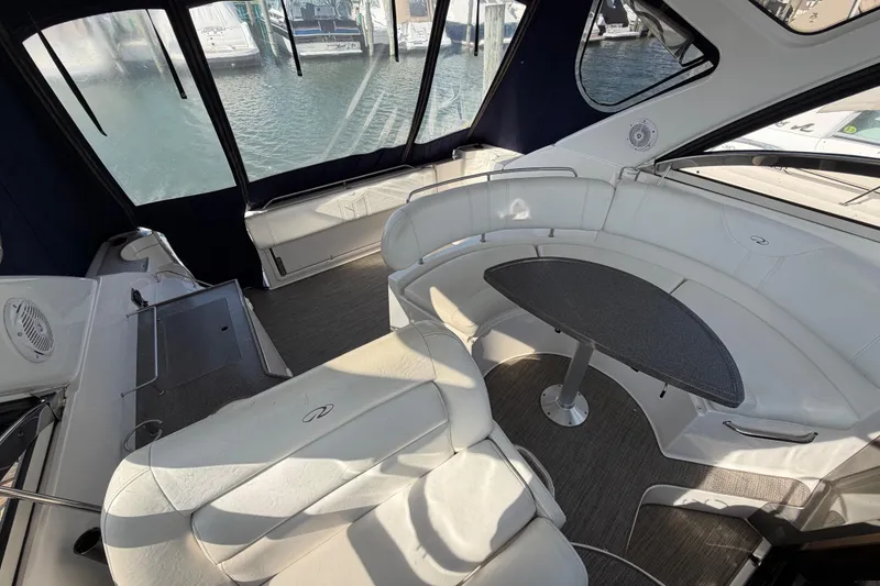 Slide: The Image of Interior of 2007 Regal Commodore 3760 IO yacht with white seating and oval table. - 16