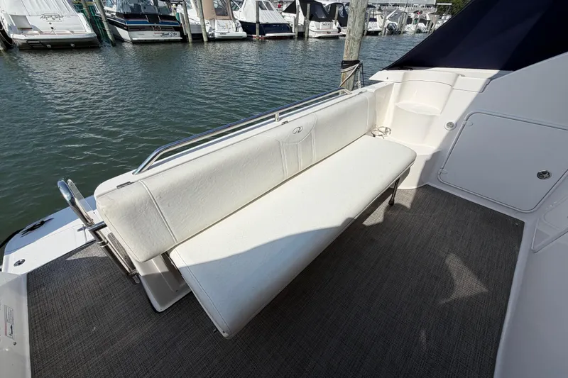 Slide: The Image of 2007 Regal Commodore 3760 IO boat with white seating, docked at marina. - 15