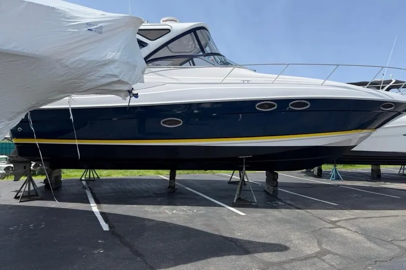 Slide: The Image of 2007 Regal Commodore 3760 IO boat on stands in a parking lot. - 56