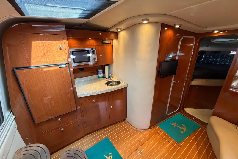 Slide: The Image of Luxurious interior of 2007 Regal Commodore 3760 IO yacht with kitchenette and wood finish. - 28