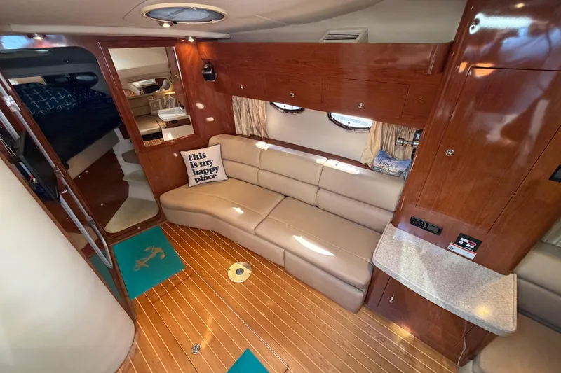Slide: The Image of Interior of 2007 Regal Commodore 3760 IO yacht with cozy seating and wooden finishes. - 27