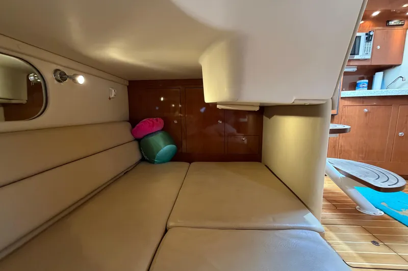 Slide: The Image of 2007 Regal Commodore 3760 IO cabin interior with seating, cushions, and kitchenette. - 41
